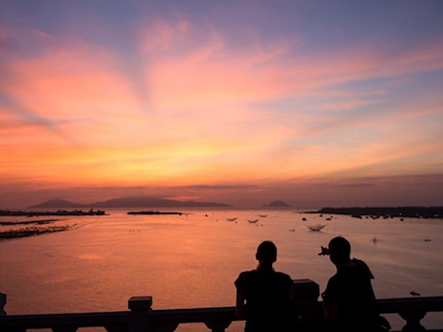 Witness sunset views from cua dai bridge at Vietnam holiday packages